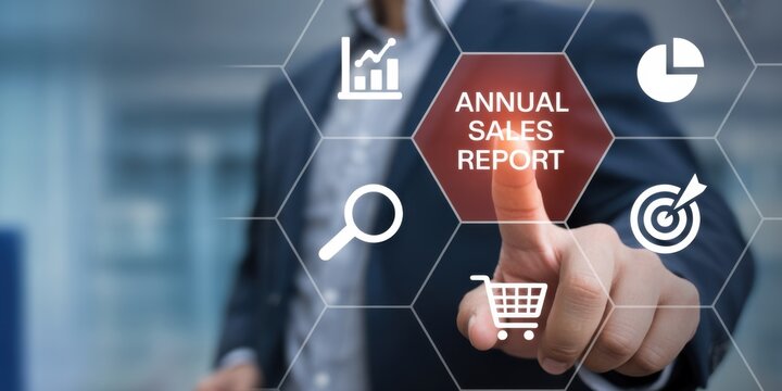 Navigating the Numbers: A person's index finger interact with interactive display Annual Sales Report, accompanied by financial icons, visualizing the analysis of fiscal performance and success. 