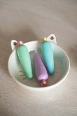 Cute stationery arrangement with carrot-shaped highlighters in cat bowl