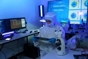 Technician working on analyzing semiconductor or microchip boards, electronics industry, electronic engineer, computer technology, CPU