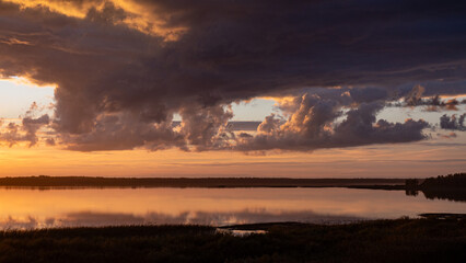 wonderful sunset by the lake, autumn landscape, sun rays reflecting on the calm surface of the lake