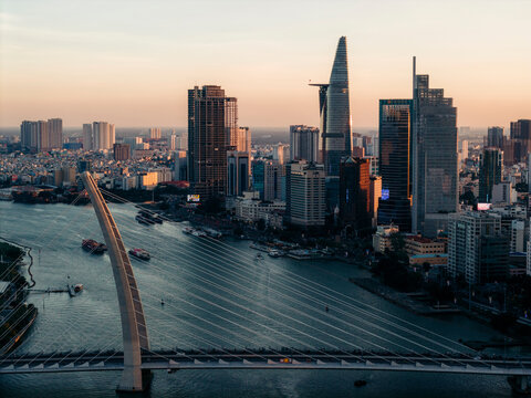 Urban skyline at sunset with a river and distinctive modern skyscrapers. Ho Chi Minh City, Vietnam
