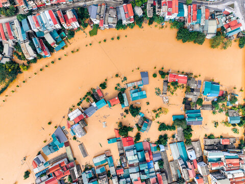 Aerial view of flooded town with submerged colorful houses along a curved river. Cao Bang city, Cao Bang, Vietnam