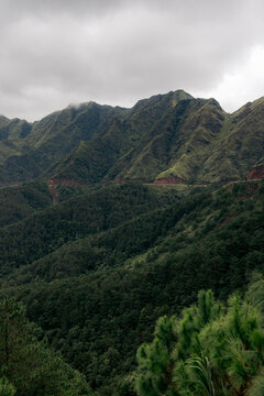 Lush green mountains under a cloudy sky with thick forested slopes. Binh Lieu District, Quang Ninh, Vietnam