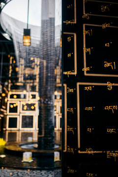Reflective black surface with gold scripts in a modern architectural setting. Black Virgin Mountain, Tay Ninh, Vietnam
