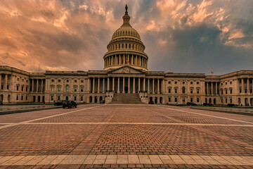 Majestic view of the US Capitol building under a dramatic, colorful sky at sunset. Washington DC, WA, USA