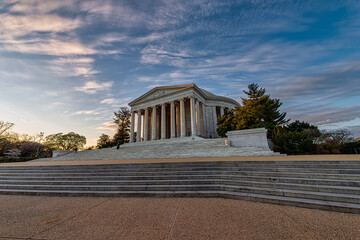 Majestic neoclassical building with columns against a vibrant sunset sky. Jefferson Memorial, Washington D.C., WA, USA