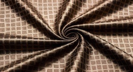 Close up of a swirling brown fabric with a square pattern creating a textured and elegant design