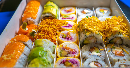 A box of assorted sushi rolls