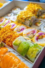 A box of assorted sushi rolls