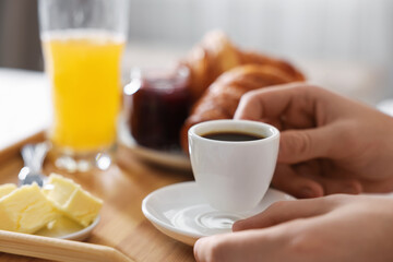 Man having breakfast in bed, closeup. Hotel room service