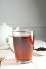 Delicious tea and brew served on white table. Space for text