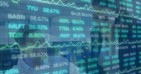 Analyzing colleagues wearing business shirts using LED panel in trading room, with green tickers