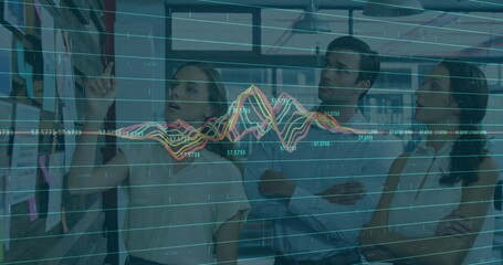 Collaborating colleagues reviewing sticky notes and printed charts in boardroom, with data overlay