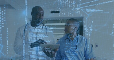 Two medical professionals in white coat and scrubs reviewing tablet in corridor, with code overlay
