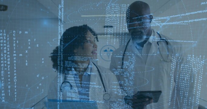 Reviewing code overlay, two doctors wearing lab coats, stethoscopes in hospital hallway with tablet
