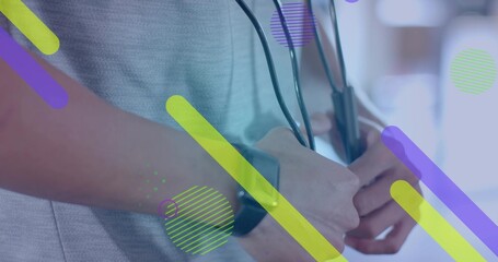 Adult male wearing grey shirt and smartwatch holding stethoscope in room, with colorful overlay