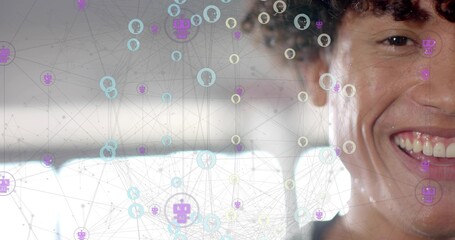 Smiling man wearing dark top sitting in car, showing network overlay with robot icons, copy space