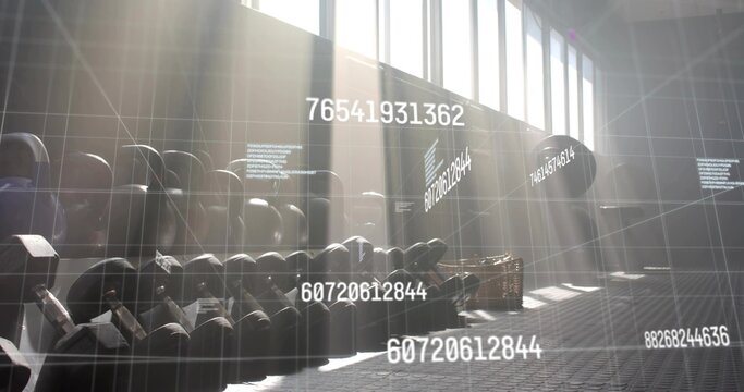 Fototapeta Black kettlebells sitting on rack in gym with panels, basket and data grid with floating codes