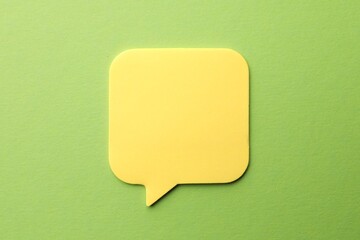 Blank paper note on green background, top view. Mockup for design