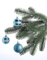 Christmas tree branch with decorative ball on white background