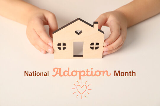 National Adoption Month poster with heart illustration. Child holding model of house on beige background, closeup - Powered by Adobe