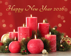 Happy New Year 2026 greeting card. Christmas composition with candles and balls, bokeh lights