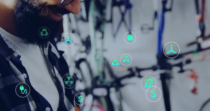 bike shop tech leaning over laptop then typing generating energy icons orbiting, visualizing data