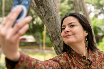 Young woman taking a selfie in nature