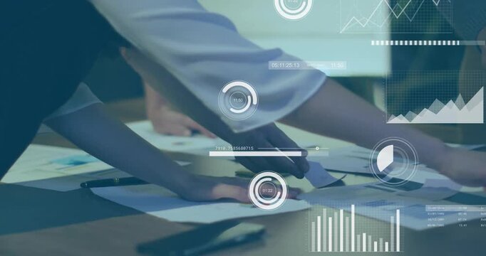 Colleagues leaning over charts, pointing segment, circling data as finance metrics updating