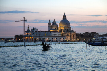 Evening view of the Basilica of Santa Maria della Salute and a gondola in Venice, Italy © Pavel