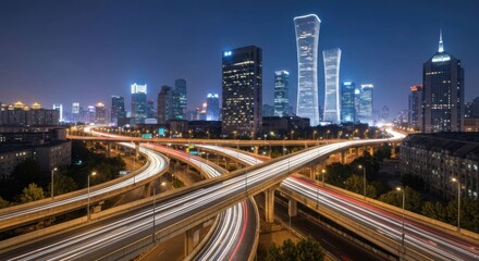 Fototapeta premium Illuminated city skyline with overpass roads and buildings at dusk