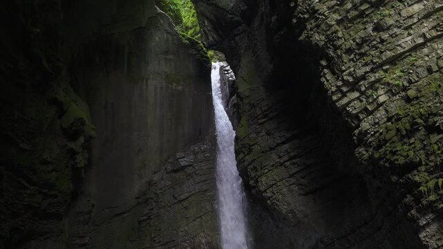 Famous Kozjak waterfall that falls into a cave carved into the rock by the action of water, Slovenia.