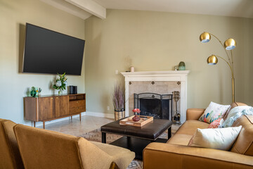 Living room interior, fireplace, flat screen TV, and mid-century modern furniture