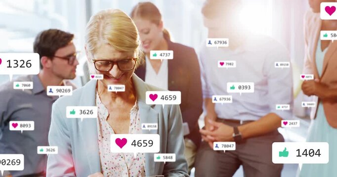 Woman tapping tablet screen, visualizing social icons climbing into thousands as colleagues lean in