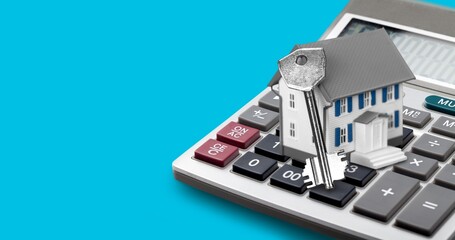 House model on office calculator. Mortgage loan