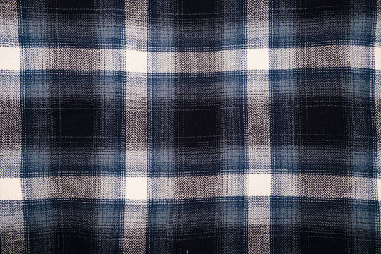 A rugged and soft flannel plaid fabric in dark tones, featuring a large, classic check pattern in navy blue, black, gray, and off-white. Perfect for grunge, lumberjack, or cozy winter fashion themes