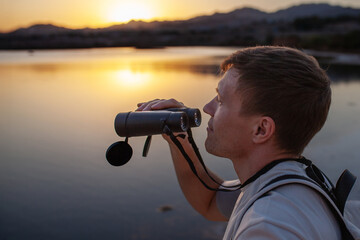 Man watching birds through binoculars, immersive point of view, Eilat Israel