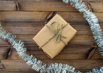 Christmas background. Christmas gifts and tinsel on a wooden background.