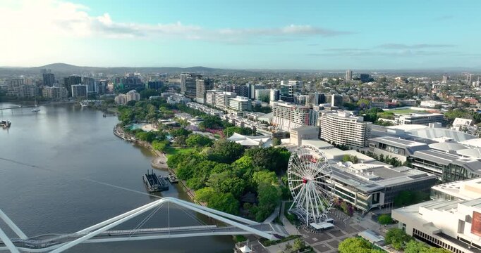 4K Aerial Push in tracking shot of west side of Brisbane City CBD also known as South Bank Precinct with new buildings and a new pedestrian bridge called Neville Bonner Bridge, Brisbane, QLD,Australia
