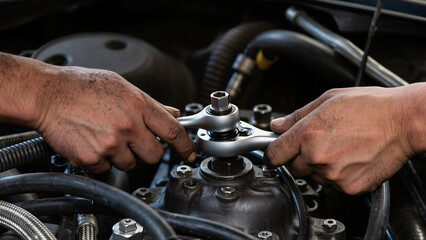 mechanic changing car engine