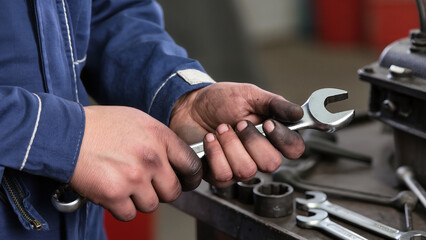 close up of a mechanic working on a car