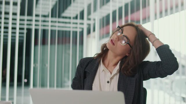 Employee Wellbeing and Corporate Wellness. Office Manager Performs Cervical Spine Stretch at Desk to Improve Posture, Prevent Neck Pain