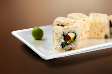 Tasty fresh salmon sushi roll on plate