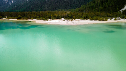 Turquoise alpine lake and white sandbar
