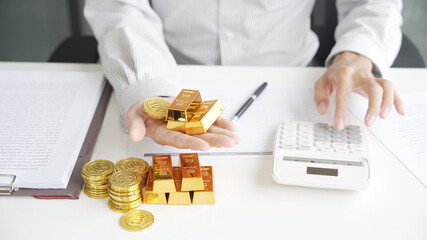 Gold Trading Businessman invest in trading gold, calculating profit price for buy and sell gold in...