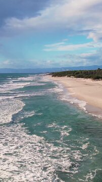 Aerial drone view on white sand Berchida beach of Sardegna. Warm turquoise sea and long beach on the Sardinia island.