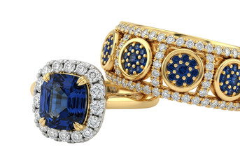 Close-up of exquisite yellow gold rings with blue sapphires and pavé-set diamonds on a transparent studio background with copy space, luxury jewelry concept