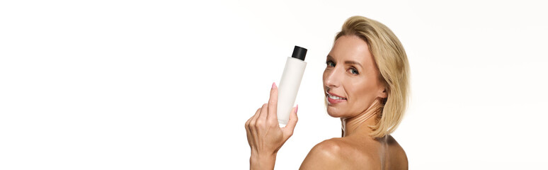 Blonde woman showcases radiant skin while promoting skin care routine