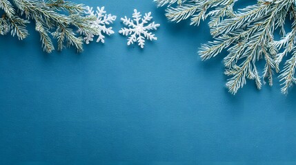 Christmas background with snowflakes and pine branches on blue background