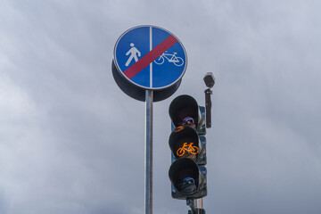 Traffic lights and stop pedestrian and cyclist shared route sign